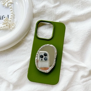 Macro detail of olive green silicone phone case with built-in oval mirror phone stand