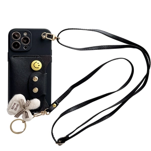 Black leather crossbody phone case with card holder, smile badge and plush charm