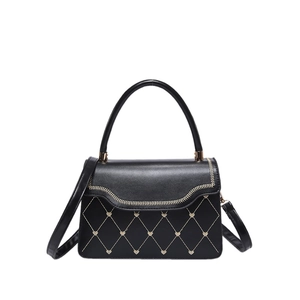 Chic black crossbody handbag with heart studs and elegant wave-cut flap detail