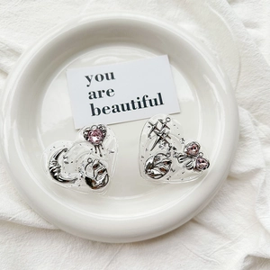 Detail view of heart-shaped resin phone grips with silver foil and pink gem accents