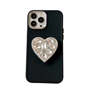 Coque iPhone noire en silicone avec support cœur en strass et bague de protection