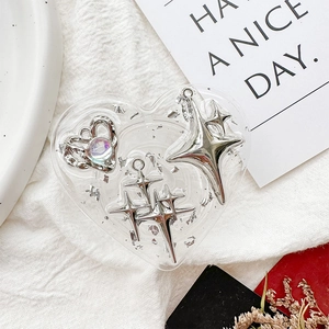Detail shot of a heart-shaped resin phone grip with silver foil and star embellishments