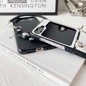 Cartoon demon folding phone case with Kuromi pendant and braided hand strap for Samsung Z Flip