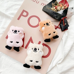 Close-up of cute plush Quokka doll charms in pink, brown and white on a lifestyle background