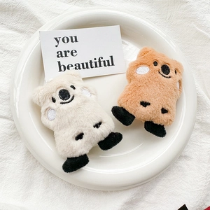 Detailed view of plush bear phone stands in cream and caramel with cute facial embroidery
