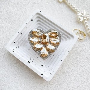 Detail of luxury heart phone grip featuring champagne rhinestones and sparkling crystals