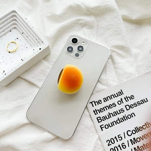 Creative 3D bread-shaped phone grip stand on a white smartphone with realistic texture