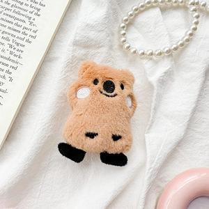 Macro shot of cute plush brown quokka phone grip with soft fur texture and embroidery