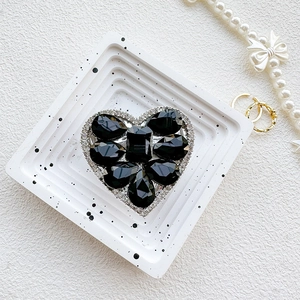 Close-up of heart-shaped phone grip with luxury black crystals and sparkling diamonds