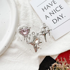 Macro detail of heart-shaped Griptok with silver foil, pink gem and star charms