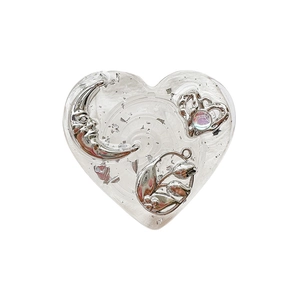Silver foil heart phone socket with crescent moon and floral resin patterns on white background