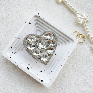 Detailed macro view of heart-shaped phone grip encrusted with luxury sparkling rhinestones