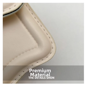 Detailed close-up of cream leather shoulder bag texture and premium stitching finish