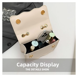 Interior view showing capacity of the cream quilted crossbody bag with daily essentials