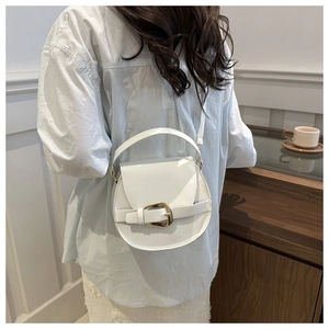 Rear view of model wearing a white semi-circular crossbody bag with golden buckle