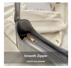 Detail showing smooth metal zipper and spacious inner compartment of the silver hobo bag