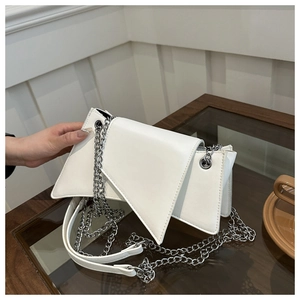 Détail du sac bandoulière blanc à rabat asymétrique avec chaîne argentée et structure