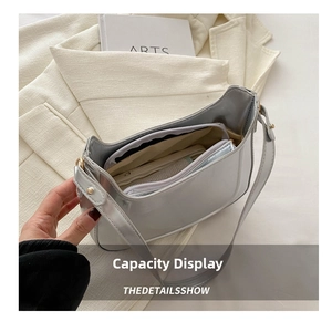 Detailed interior of the metallic silver bag showing spacious storage and inner pouch