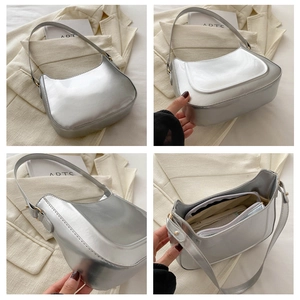 Detail view of metallic silver crescent shoulder bag with inner zipper pouch and mirror finish