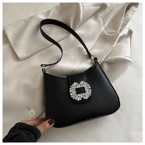 Chic black PU leather half-moon hobo bag with a luxury rhinestone buckle on white fabric