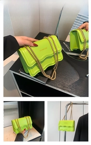 Detail of neon green PU leather bag with wave-edge flap and chunky gold chain