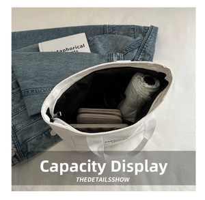 Spacious interior of white canvas tote bag showing storage for umbrella and tablet
