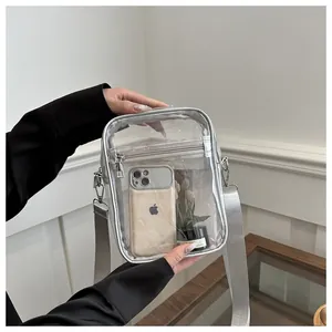 Detailed view of clear PVC crossbody bag with silver trim and adjustable shoulder strap