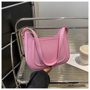 Detailed view of pink glossy patent leather hobo bag with smooth reflective finish