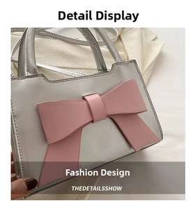 Detailed close-up of a silver PU leather handbag with a large pink decorative bow accent