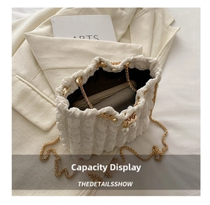 White bubble texture bucket bag interior view showing capacity with pearl closure