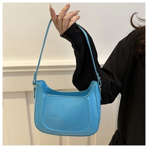 Detail view of sky blue glossy shoulder bag featuring polished metallic buckle adjustment