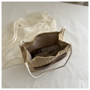Top view of woven tote bag interior showing spacious storage for umbrella and wallet