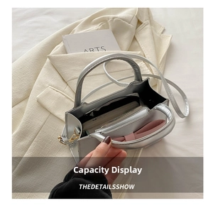 Internal view of silver crossbody bag showing storage capacity and zippered compartment