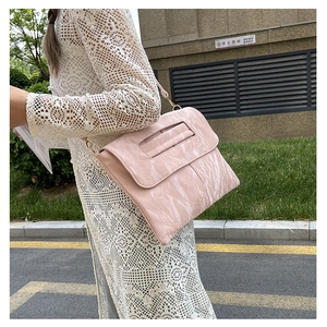 Détail du sac à bandoulière rose à motif marbré avec texture plissée et boucle en métal