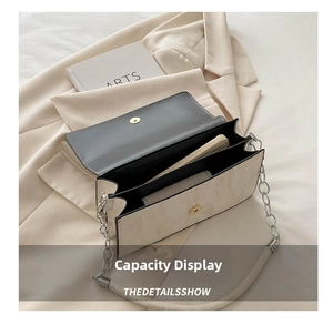 Internal view showing double-compartment capacity of contrast leather crossbody bag