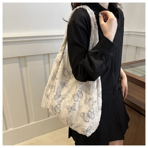 Detail of blue butterfly pattern on high-capacity off-white textured canvas tote bag