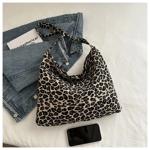 Detail of leopard print hobo bag with wide strap and canvas texture for daily styling
