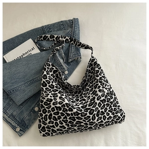 Macro view of leopard print nylon tote bag with black and white texture details