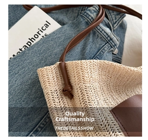 Close-up of woven straw tote bag featuring brown leather strap and intricate texture