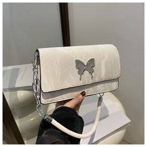 Detail of marble pattern white leather bag with silver butterfly clasp and chain strap
