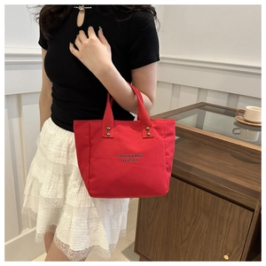 Detail of red tote bag with metal rivets and Fashion & Bags Leather logo print