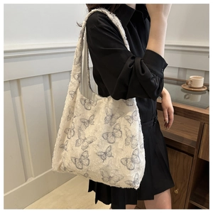 Detailed view of large canvas tote bag featuring delicate blue lace butterfly patterns