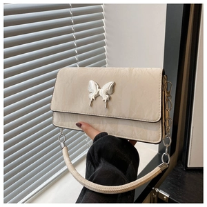 Detail of quilted marble texture shoulder bag with silver butterfly clasp and leather strap