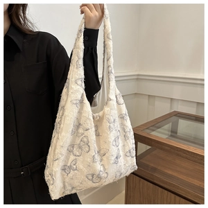 Detail of floral tote bag showing textured blue butterfly print and fuzzy fabric finish