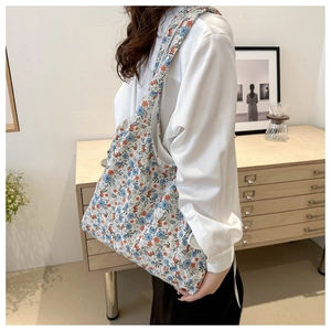Floral canvas tote bag shown on shoulder in a cozy home setting for daily lifestyle use