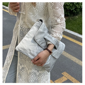 Silver metallic pleated large clutch bag for women paired with casual outdoor outfit