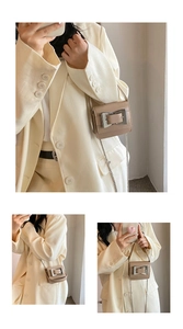 Detail view of mini camel shoulder bag with silver buckle and sleek chain strap