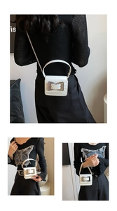 Detail view of mini white crossbody bag with silver square buckle and chain strap