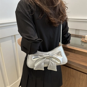 Silver metallic underarm bag featuring a 3D bow and crocodile pattern for women