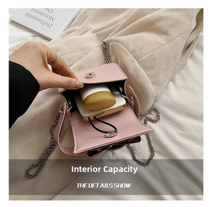 Detailed interior of a pale pink mini chain bag showing storage space for essentials